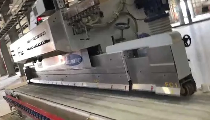 The edge profiling head travelling along the edge of a slab