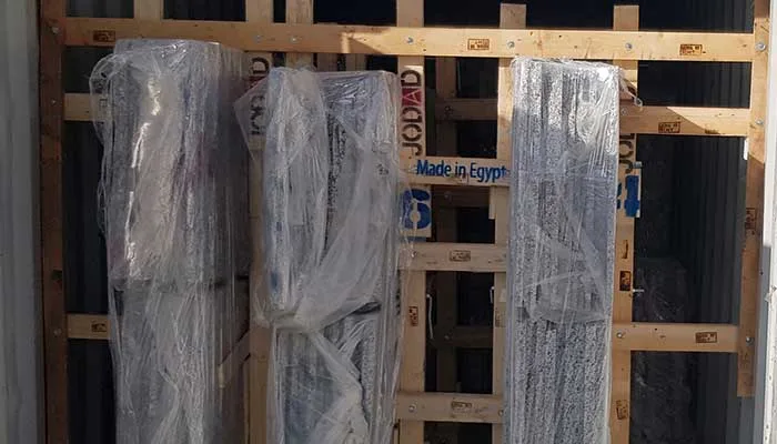 Wrapped granite bundles in wooden frames marked Made in Egypt