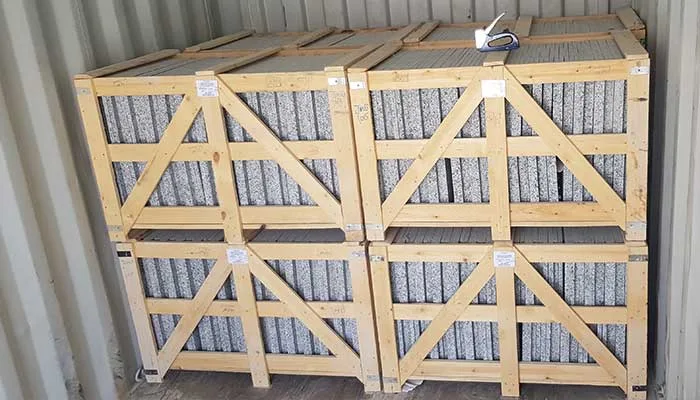 Grey granite tiles crated and loaded into a shipping container