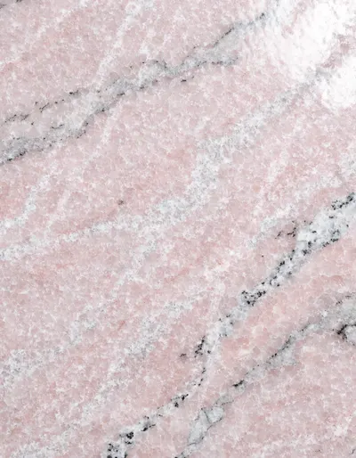 A polished slab of Rosa Sinai granite, pink with a fine crystalline sparkle