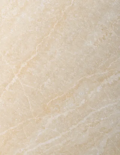 A polished slab of Golden Cream limestone, a warm golden ground with almost no veining