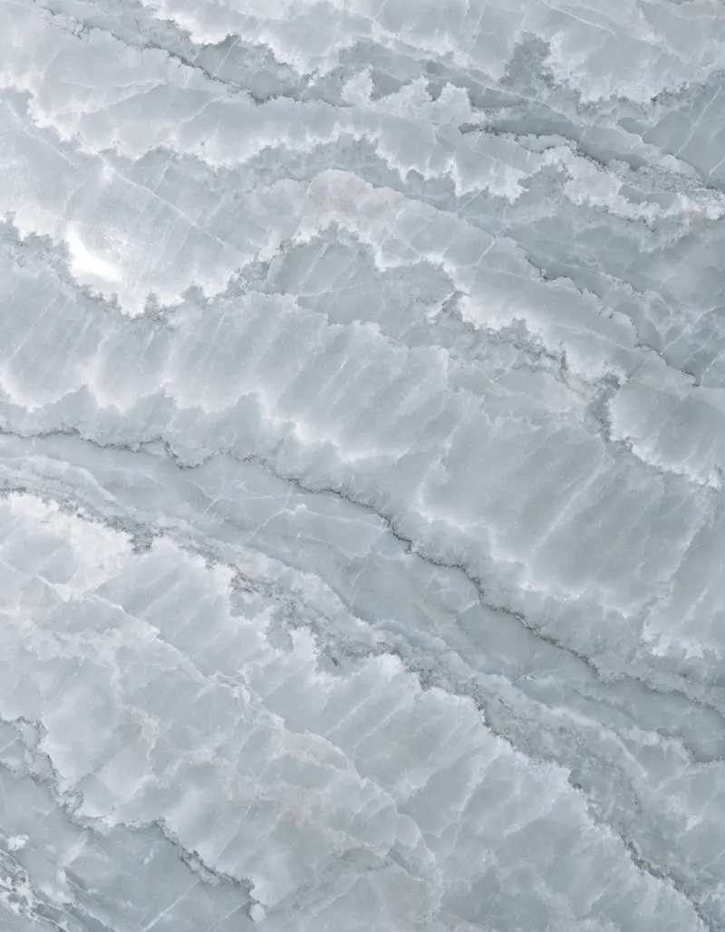A polished slab of Milly Grey marble, cool grey with soft, drifting cloud-like movement